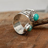 Adjustable vintage silver ring with natural stone on brown background