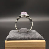 Vintage silver ring with amethyst on a grey background