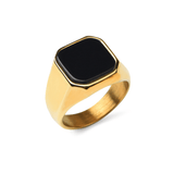 Gold ring with Onyx stone in stainless steel on a white background