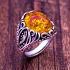 Metal ring with embedded amber resin