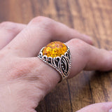 Metal ring with embedded amber resin