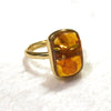 Silver ring with natural amber stone on a white background