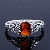 Vintage sterling silver ring with amber stone on a grey background.