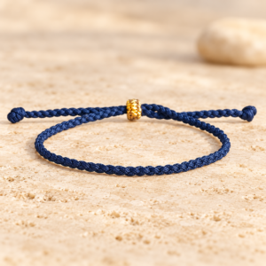 Blue Tibetan macrame knot bracelet on warm river stone