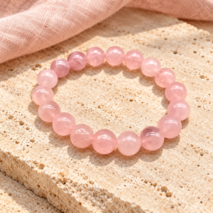 Rose quartz beaded adjustable bracelet on natural travertine stone