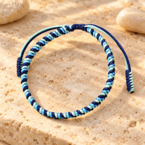 Handmade blue Tibetan lucky bracelet displayed on warm natural stone